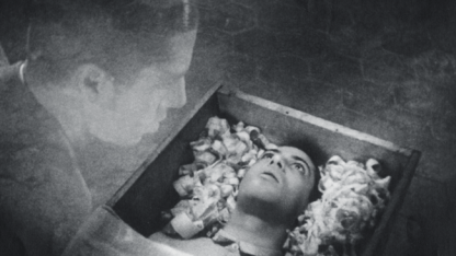 man stares at his head in a box