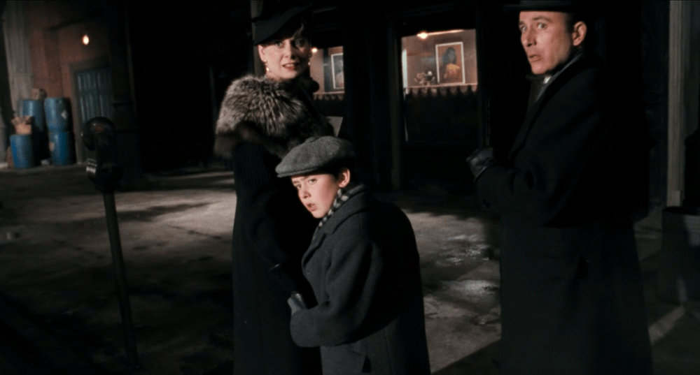 a little boy with his parents on a quiet street