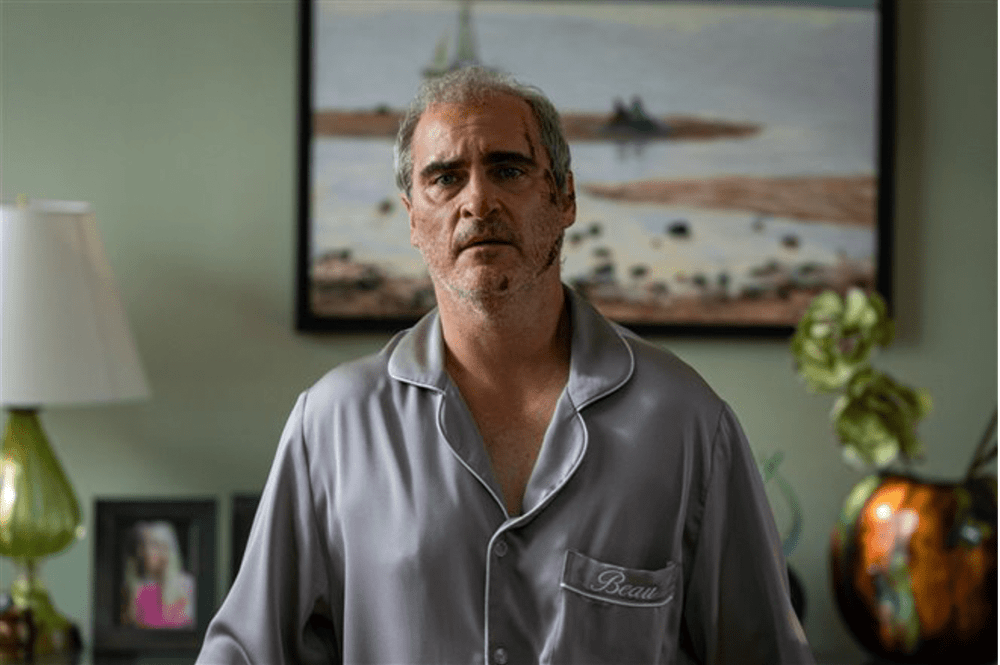 A disheveled man wearing pajamas looks concerned